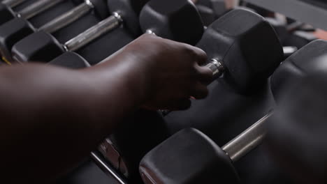 person lifting dumbbells in gym