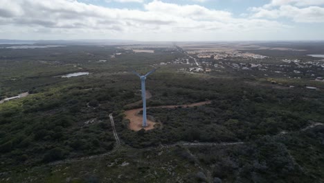 Rotating-win-d-turbine-on-green-hill-in-front-of-ocean-in-Australia