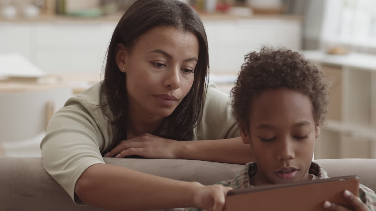 Mother and Son Learning Together on a Tablet