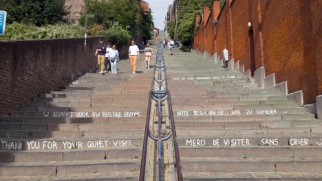 people walking on the staircase montagne de bueren in liège, belgium. the famous stairway has 374 steps and was built in 1881