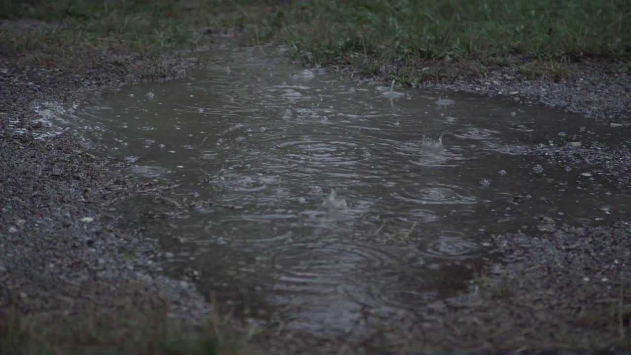 Close shot of darken rain puddle, 4K