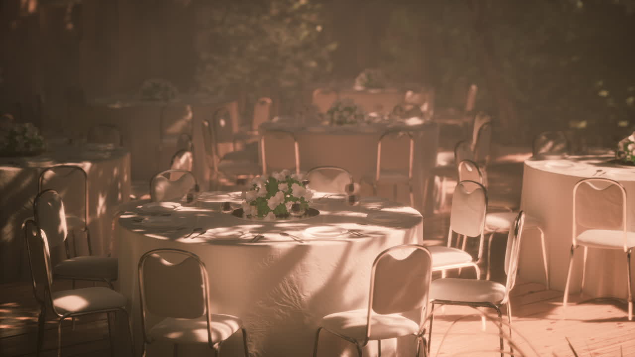 Elegant outdoor dining setup with floral arrangements in natural light