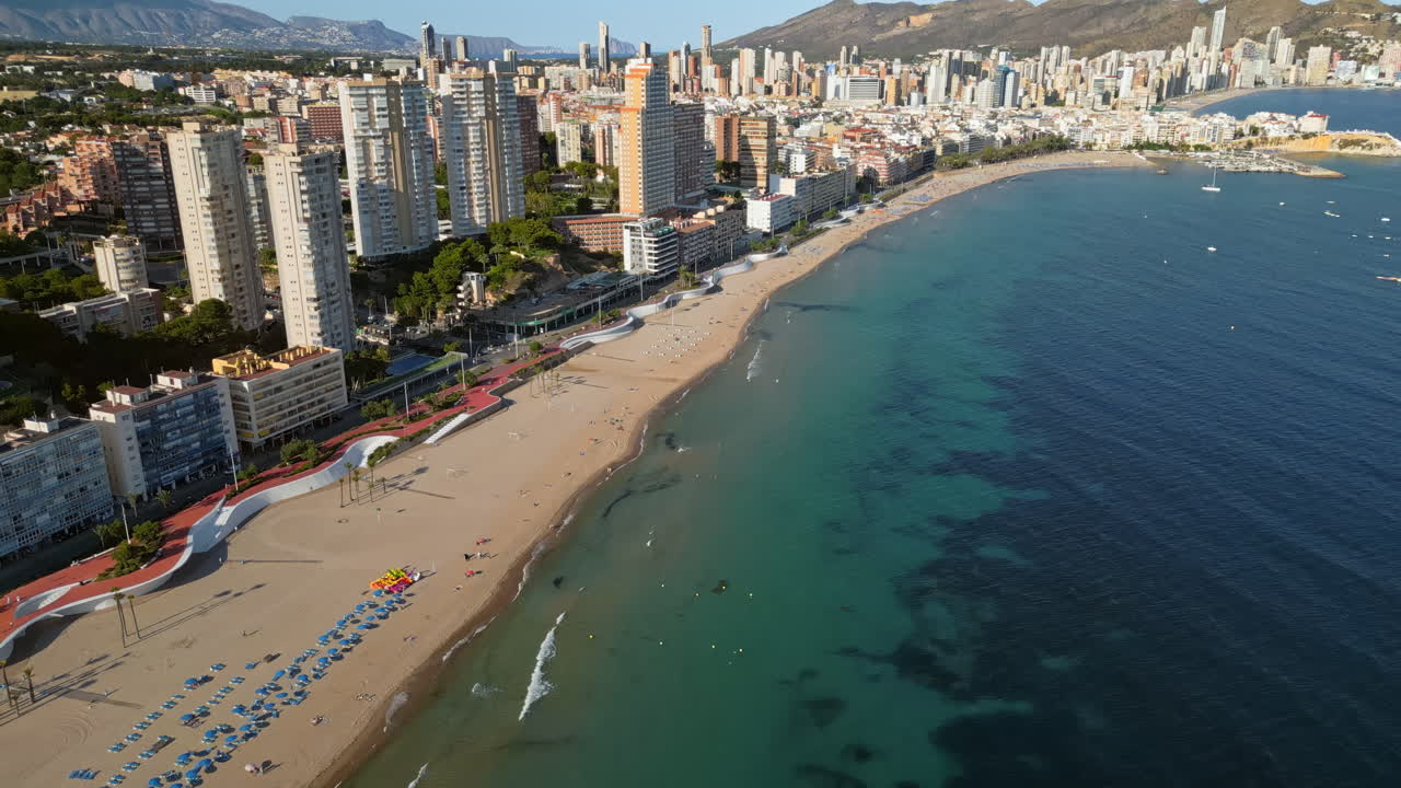Aerial drone view of the buildings along the coastline and the sea in Benidorm, Spain in daylight