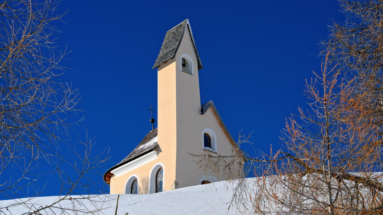 View of the Chapel of the Alpini at the Gardena Pass in the Dolomites, Italy with the blue sky on the background
