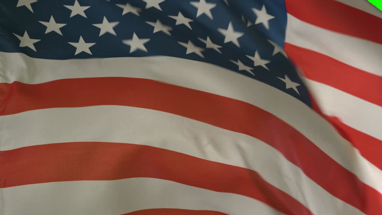 Close up of American flag blowing by wind