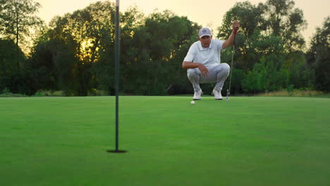 Golf-player-looking-course-on-lush-grass-field.-Golfer-coach-sit-on-fairway-game