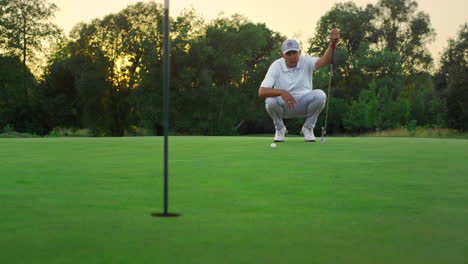 golf player looking course on lush grass field. golfer coach sit on fairway game