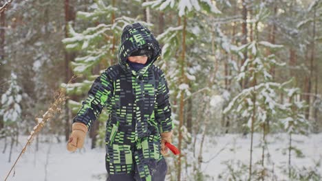 boy in winter snow forest