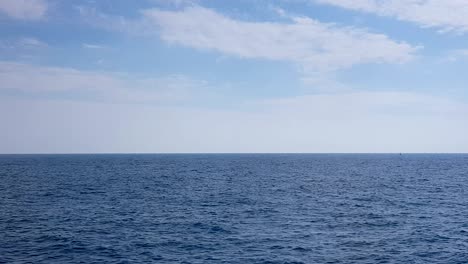 view of the ocean and clouds in the sky. blue sky with clouds in sunny weather over the ocean.