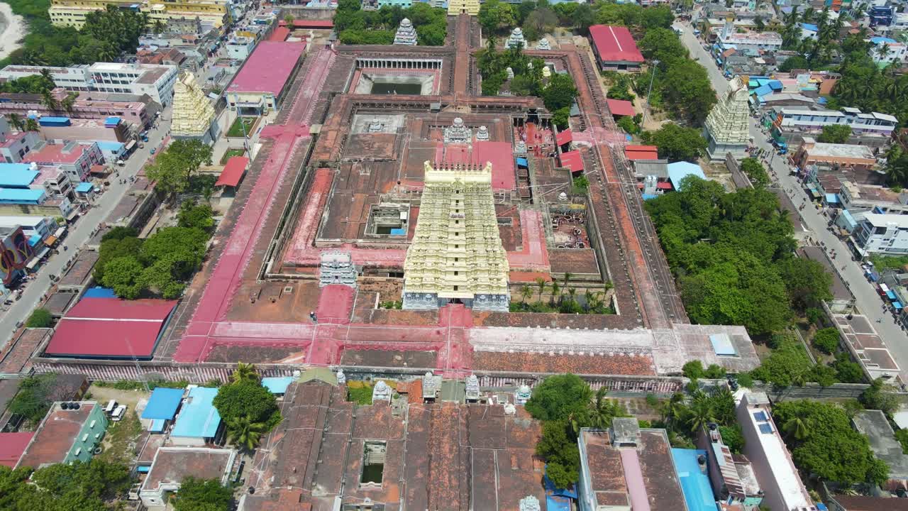 Panoramic aerial drone shot of Rameshwaram city, focusing on the temple as the central landmark.