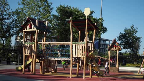 children playing at a colorful wooden playground