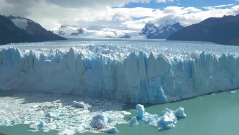 zooming in a massive glacier calving icebergs into the sea