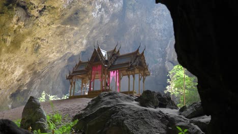 thai pavilion in phraya nakhon cave illuminated by natural light, serene and majestic, surrounded by rock walls