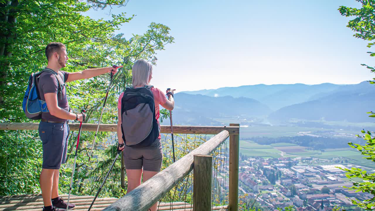 Joyful hikers arriving to green window panoramic viewing point, Radlje ob Dravi