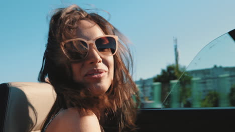 happy woman in a convertible car