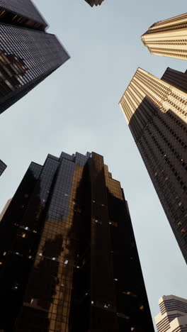 looking up at skyscrapers in a city