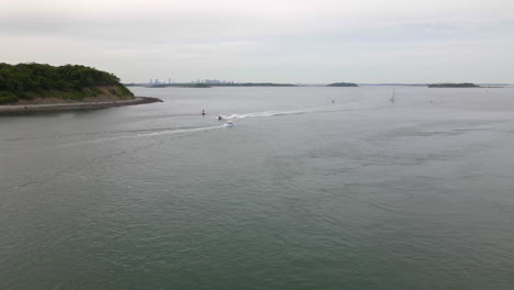 Static-drone-shot-of-two-motor-boats-crossing-paths