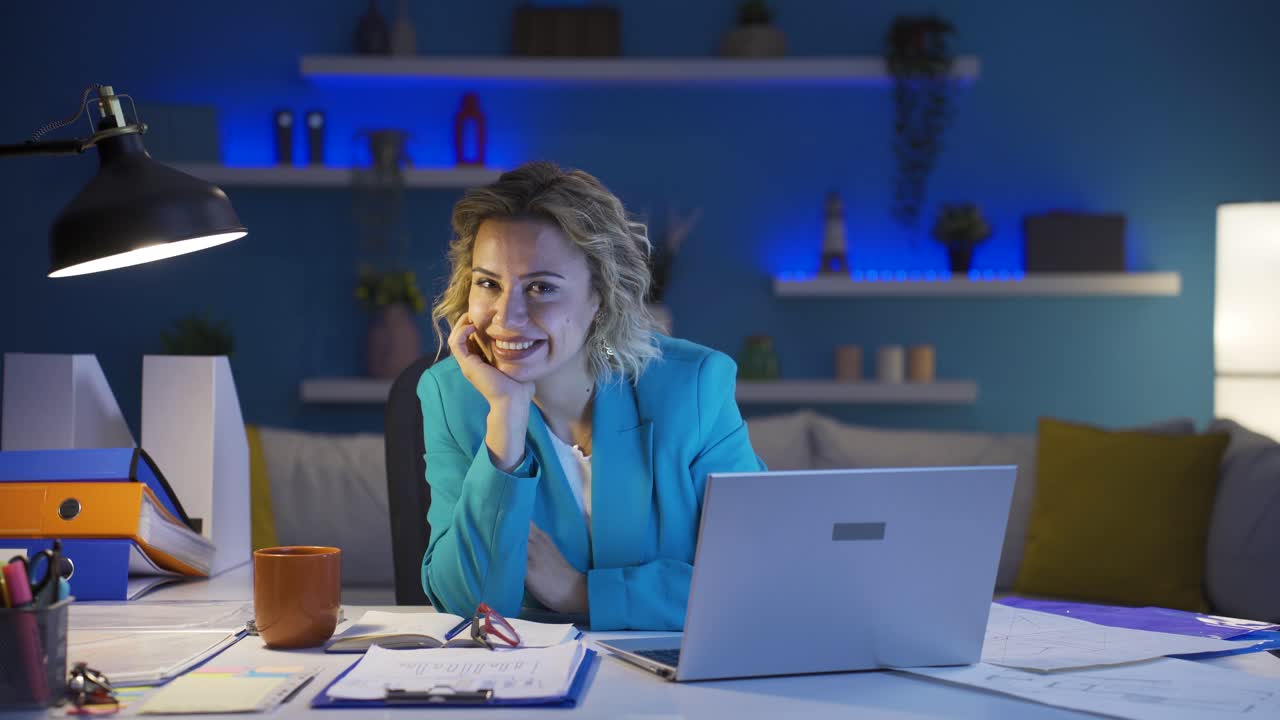 Home office worker woman winks at camera.