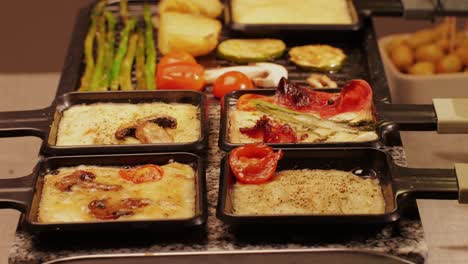 french swiss or spanish restaurant with traditional tapas food, spanish cuisine, delicious tapas and cheese plate, bruschetta with cheese, olives dry tomatoes and tasty sandwich bar appetizer, buffet