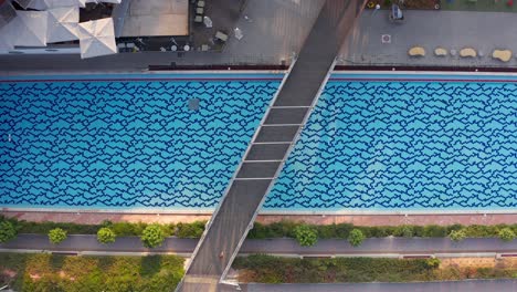 aerial view of a swimming pool with a bridge