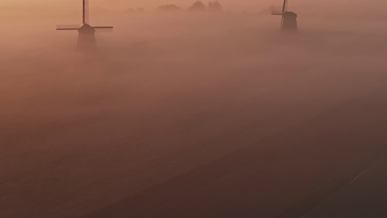 Museummolen and Grote Kerk in fog,Netherlands