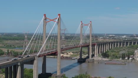 aerial view of cable-stayed road and railway bridge over paraná river. buenos aires province, argentina. 4k.
