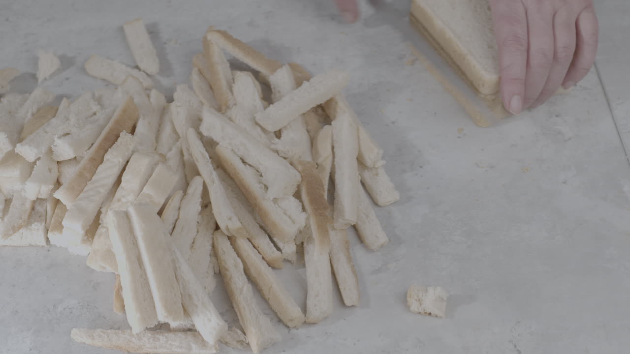 Tomada Estática De Uma Pilha De Crostas De Pão Sendo Aumentada Com Um Chef Cortando Mais Crostas De Fatias De Pão