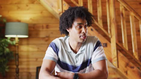 Happy-african-american-man-sitting-at-table-and-having-video-call,-slow-motion