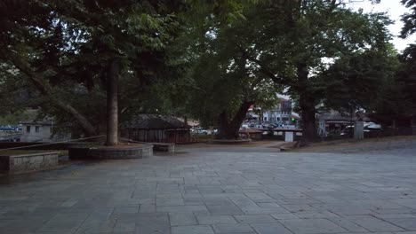 Empty-town-square-with-trees-in-mid-evil-town,-Greece,-no-people