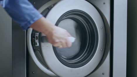 loading washing machine. load clothes to washer machine. laundry washing