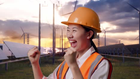 close up of side view of asian female engineer with safety helmet screaming goal celebrating working with solar panel and wind turbines