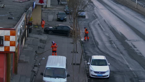 Chinese-street-sweepers-work-along-a-roadside-in-China