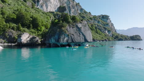 kayakers exploring capillas de mármol on lake general carrera