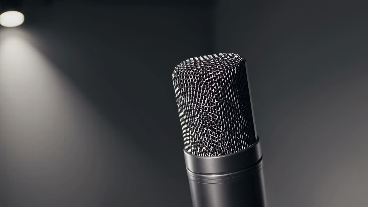 Close-up of a microphone from a low angle, set against a dimly lit background, ideal for a podcast