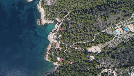 Forward-straight-down,-slightly-rotating,-drone-shot-over-the-island-of-Aigina-in-Greece
