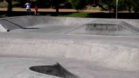 three generations of skateboarders hight five on the top of the ridge?.