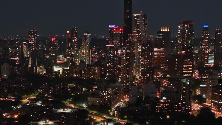 Nighttime aerial view of New York City highlights urban lights