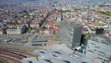 Aerial-establishing-shot-of-Vienna-train-station-as-trains-come-and-go