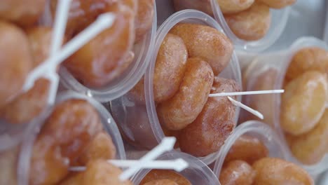 delicious, glazed doughnuts in transparent cups