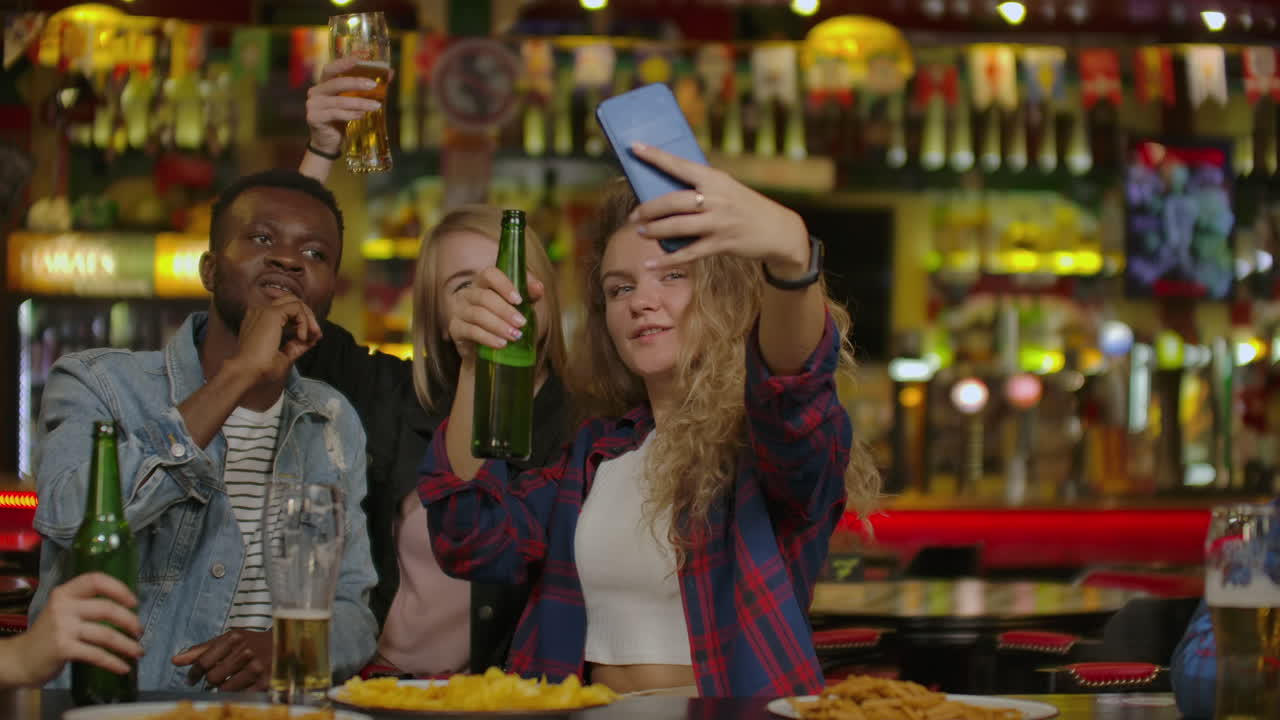 Amici maschi felici che si scattano un selfie e bevono birra al bar o al pub. Concetto di svago, amicizia, tecnologia e festa tra persone - amici maschi felici che si scattano un selfie