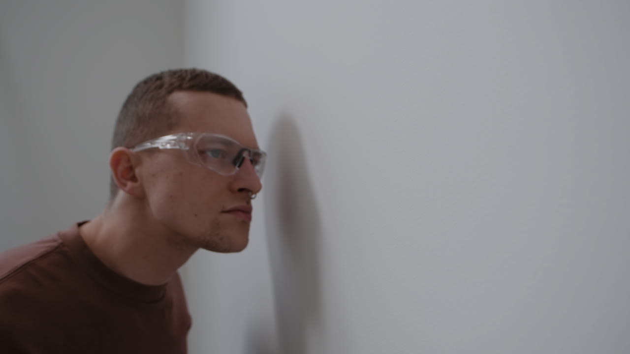 Man Inspecting a Wall