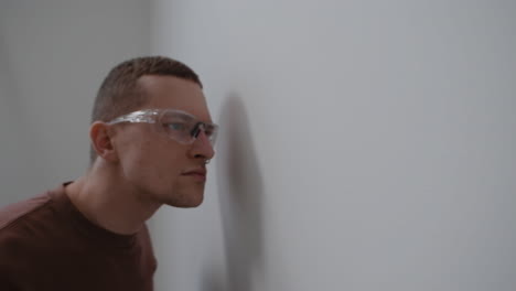 man inspecting a wall