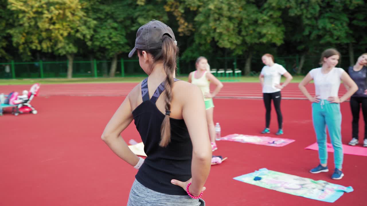 Happy athletic group training. Group free exercise class for people of different age