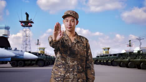 military personnel gesturing stop at airbase