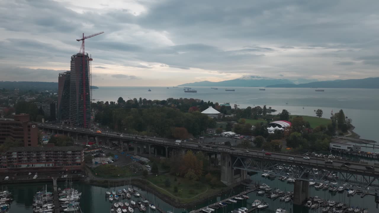 Wide panning aerial shot of Burrard Bridge at Vanier Park on a rainy morning in Vancouver, British Columbia, Canada. 4K