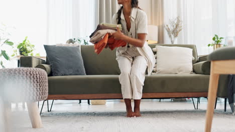 Woman-on-sofa-in-home-with-clean-laundry