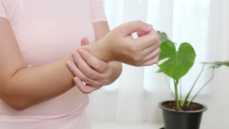 women doing hands stretching and exercising to protect office syndrome and hand arthritis after work at home office day