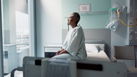 sad, patient and thinking in hospital with window