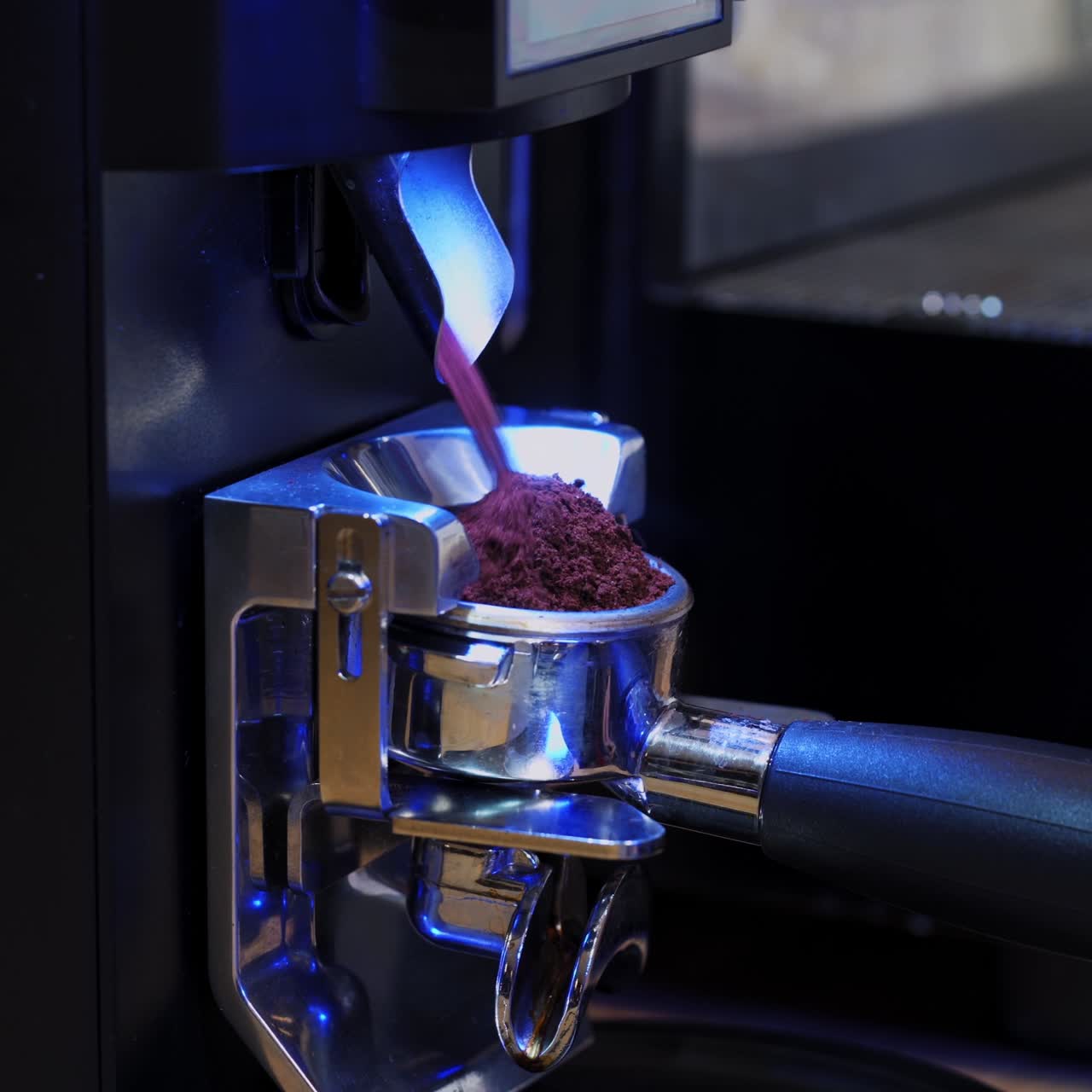 Coffee machine. Grinding coffee beans pouring. Process of making coffee in a modern coffee machine. Close-up.