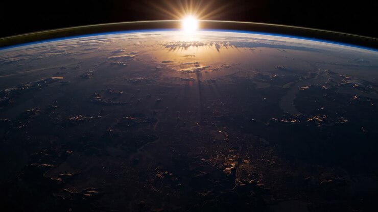 Earth at night with city lights and sunrise
